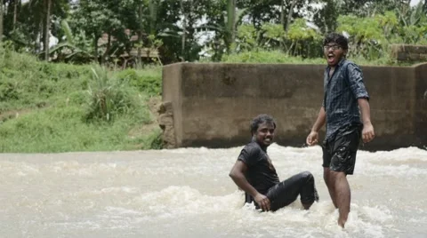 Indian folks playing in the river Stock Footage 59823976