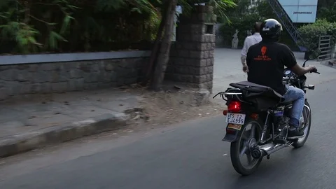 Indian food delivery guy  on a motorbike Stock Footage