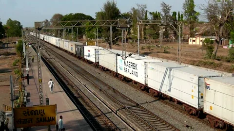 Indian freight cargo container train crossing railway station Gujarat India Video stock 130598373