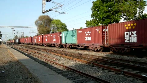 Indian freight cargo container train crossing railway station at Gujarat India 스톡 동영상 130599282
