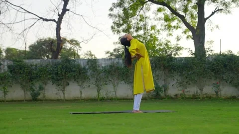 Indian girl doing back stretch exercise Stock Footage 242085196
