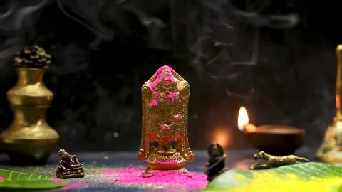 Indian god gold figure statue with diya and smoke Stock Footage