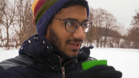 Indian Guy in Glasses Drinks Coffee in the Winter in the Forest Stock Footage 101561975