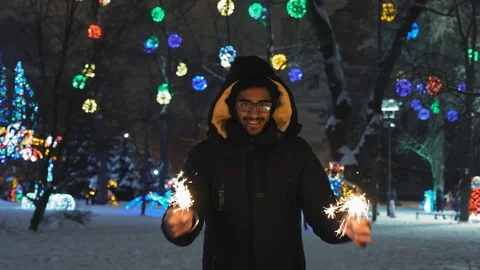 Indian Guy in Glasses Holds in Hands the Bengal Lights in the Park Stock Footage 101666766
