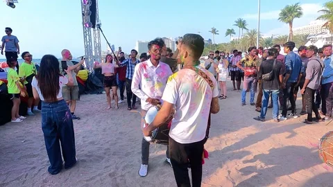 The Indian guy plays the traditional drum, and the other guy is dancing to the 動画素材 332760821