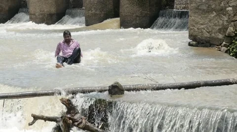 Indian guy sitting below dam Stock Footage 59823663
