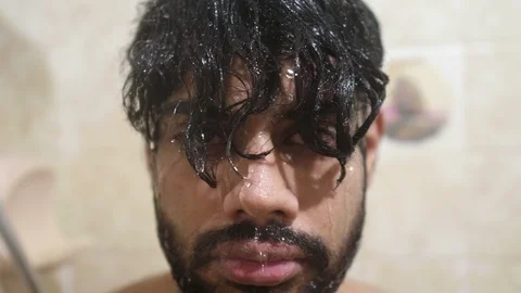 Indian guy taking shower in shower booth... Stock Video Pond5