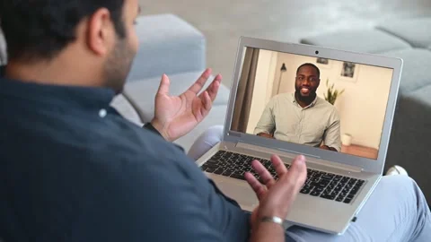 Indian guy using computer app for video connection with african-american male Video stock 153921102