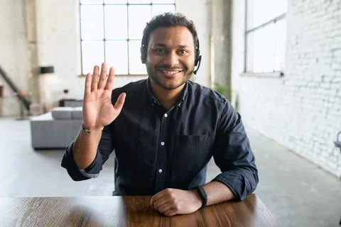 Indian guy using headset in modern office Stock Photos