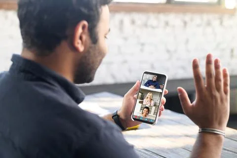 Indian guy using mobile app for video connection Stock Photos