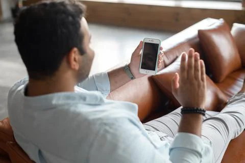 Indian guy using new mobile app for video connection, video call Stock Photos