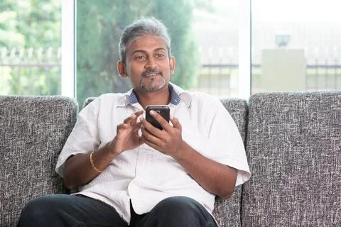 Indian guy using smartphone Smartphone mobile apps concept. Indian mature ... Stock Photos