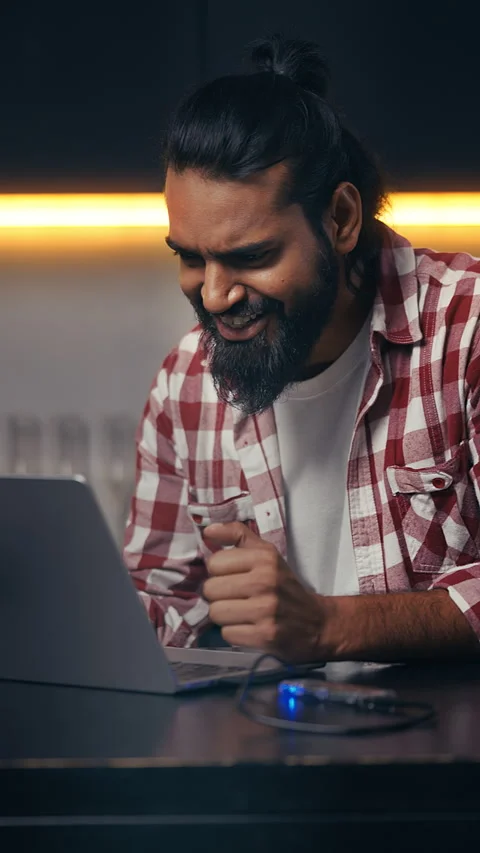 Indian IT engineer typing on laptop at home, satisfied with project completion Stock Footage 316838276