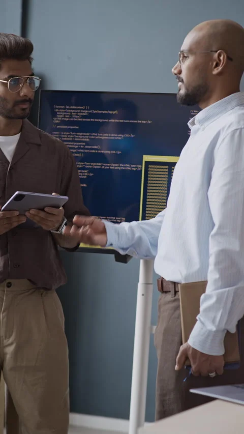 Indian IT Professionals Discussing Code on Screen in Office Stock Footage 337490712