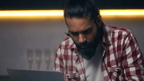 Indian IT specialist facing software error message while working on laptop Stock Footage 316836477