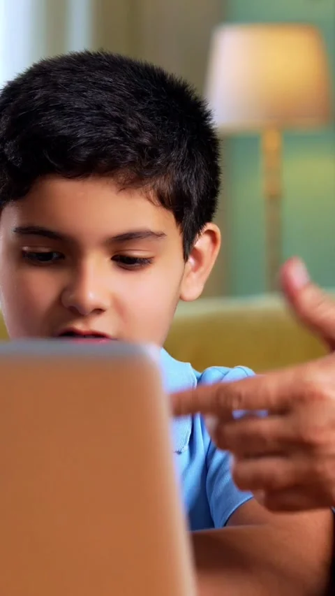 Indian kid studying on laptop while father helping during online education Stock Footage 342758176