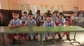 Indian kids sitting at the desks and waving HD Footage