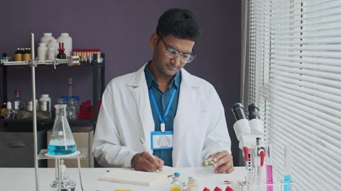 Indian Lab Worker Looking at Medicine in Bottle Stock Footage 305507176