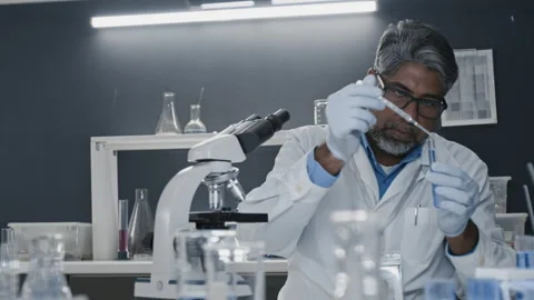 Indian Lab Worker Preparing Solution and Working with Microscope Stock Footage 304122459