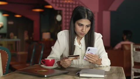 Indian lady doing online payment using her bank ATM card and using smartphone. Видео 232575560