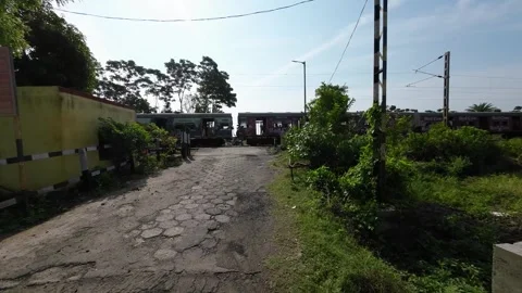 Indian Local Train Passing a Rural Railway Crossing in Kolkata, West Bengal Video stock 312889192