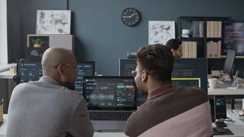Indian Male Developers Analyzing Data Dashboard on Laptop Screen in Office Stock Footage 337480263