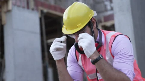 Indian male engineer depressed while sitting alone at construction site. Stockbeeldmateriaal 161876669