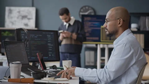 Indian Male IT Developer Eating Snack and Checking Phone during Office Break Stock Footage 337476533
