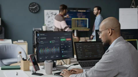 Indian Male Software Developer Coding on Computers in Diverse Tech Office Stock Footage 337483729