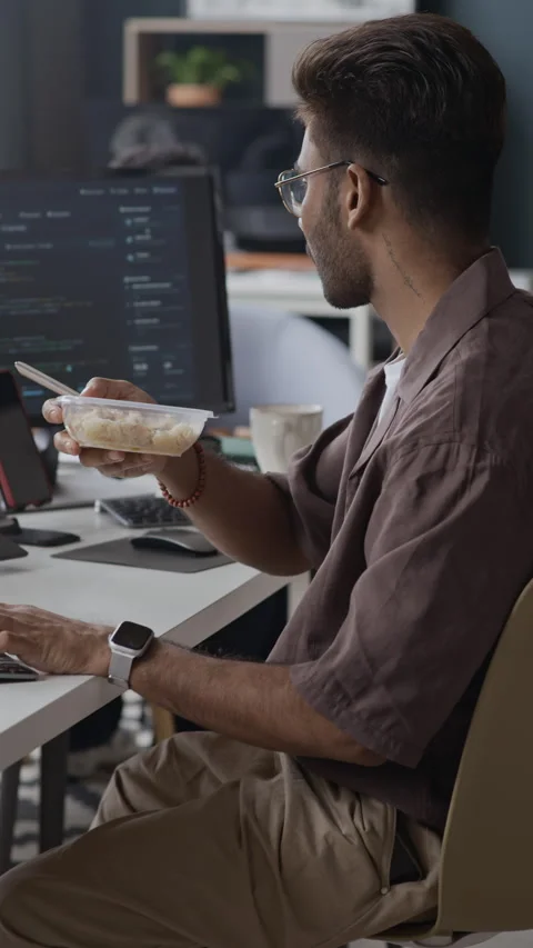 Indian Male Software Developer Eating Lunch at Desk in IT Office Stock-Footage 337484784