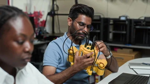 Indian Man Assembling Robotic Device in Robotics Lab Stock Footage 343514004