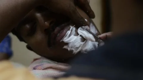 Indian man being shaved Stock Footage 59998578
