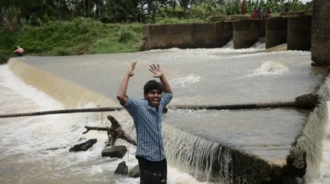 Indian man being silly by the river Stock Footage 59824307