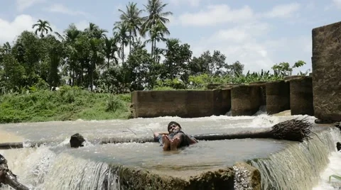 Indian man chilling in the river Stock Footage 59824550