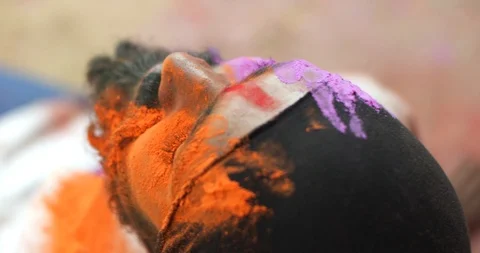 Indian man close-up of face smeared with bright Holi colors Video stock 125374701