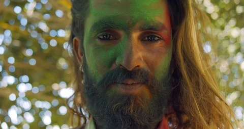 Indian man close-up of face smeared with bright Holi colors Stock Footage 125375995