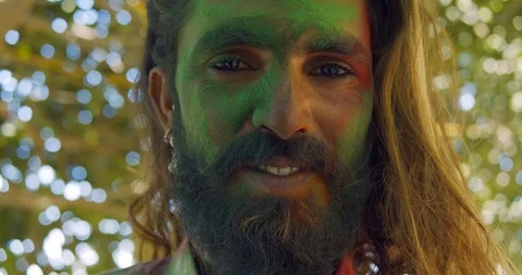 Indian man close-up of face smeared with bright Holi colors Stock Footage 125376006
