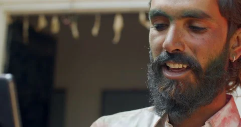 Indian man close-up of face smeared with bright Holi colors Video stock 125376380