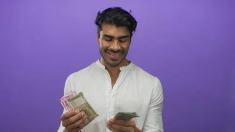 Indian man counts stacks of rupee banknotes with hands in studio; financial.. 스톡 동영상 313457262