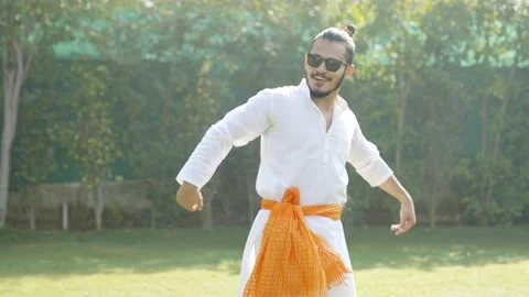 Indian man doing Bhangra dance in a park Stock Footage 230170352