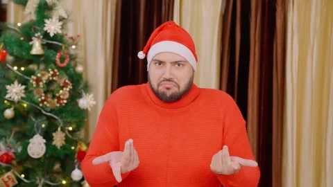 Indian Man Doing I Dont Know Gesture with Christmas Tree in background Stock Footage 296897047