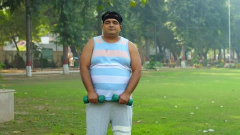 Indian man doing side and front dumble raises during his fitness training - s... Stock Footage 264016014