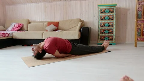 Indian man doing yoga while inside the house on the floor. Stock Footage 151720464