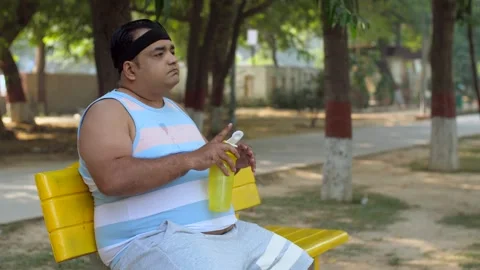Indian man drinking water after the workout in the park - water, thirsty man,... Stock Footage 264016030