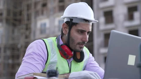 Indian man engineer survey on construction site while using laptop Vidéo 161811774