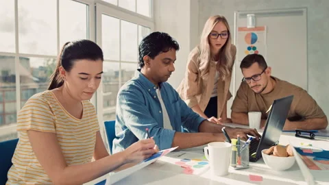 Indian Man explaning Project to his Team. Creative team Working at Office. Team Stock Footage 217823232