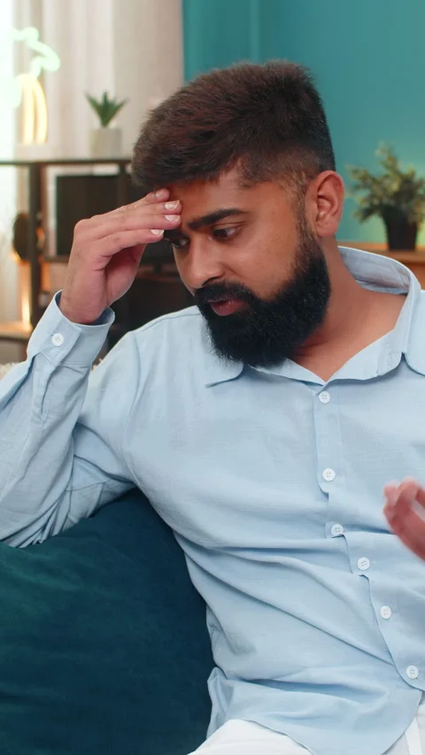 Indian man facepalm slaps forehead disappointed smartphone mistake shows Stock Footage 313364297