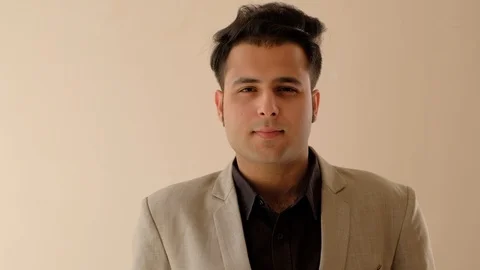 Indian man in formals looks at camera and talks Stock Footage 100529651