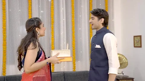 Indian man giving gift boxes to his wife Stock Footage 249400670