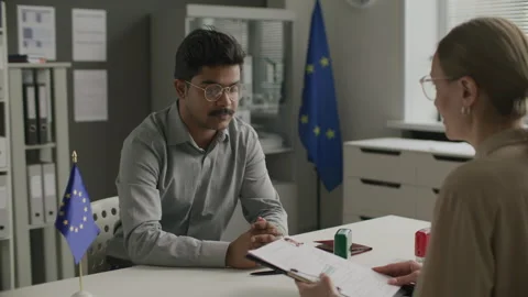 Indian Man Having Interview with Female Visa Officer at European Union Embassy Stock Footage 304331600